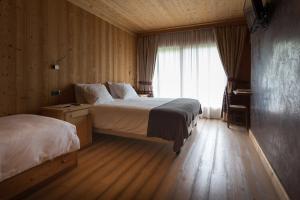 Postel nebo postele na pokoji v ubytování Hotel Funivia