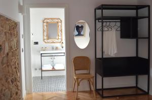 a room with a chair and a mirror and a bathroom at Lugar das Marías in Jove +63 photos