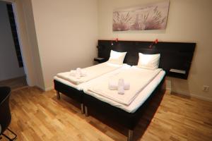 Un pat sau paturi într-o cameră la City HotelApartment