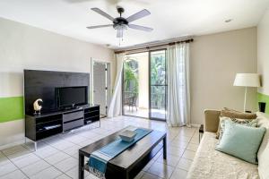 a living room with a couch and a tv at Pacifico Lifestyle L1009 in Coco