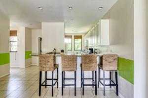 a kitchen with white cabinets and bar stools at Pacifico Lifestyle L1009 in Coco