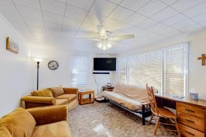 a living room with a couch and a ceiling fan at Voyagers Cabin in Eagle River