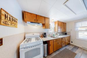 a small kitchen with a stove and a sink at Voyagers Cabin in Eagle River