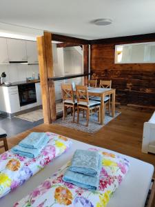 a kitchen and dining room with a table and chairs at Little Chalet Pirelli 1783 in Interlaken