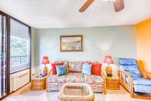 a living room with a couch and a chair at Kona Pacific C421 in Kailua-Kona