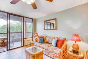 a living room with a couch and a table at Kona Pacific C421 in Kailua-Kona