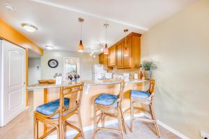 a kitchen with two bar stools and a counter at Kona Pacific C421 in Kailua-Kona