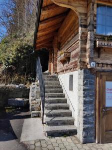 a building with stairs leading up to a door at Little Chalet Pirelli 1783 in Interlaken