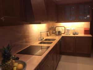 a kitchen with a sink and a bowl of fruit on the counter at Casa da Quinta in Funchal