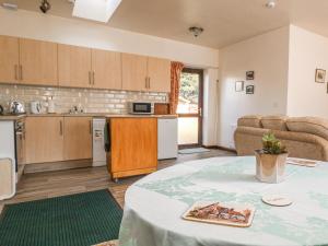 a kitchen and living room with a table at Shamrock in Selby