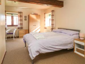 a bedroom with a large bed in a room at Thistle in Selby