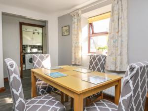 a dining room with a wooden table and chairs at Rose in Selby