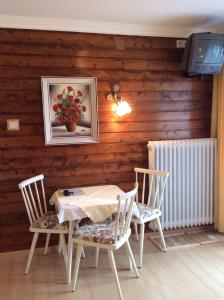 a dining room with a table and chairs and a tv at Ferienhaus Emberger in Wagrain