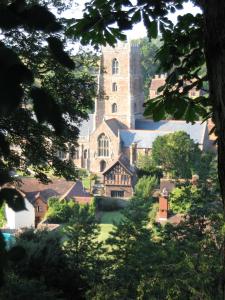 a large church with a tower in the distance at House in historic village - Sleeps 6 in Minehead