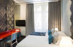 سرير أو أسرّة في غرفة في Hotel D - Strasbourg