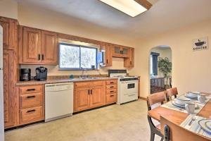 a kitchen with wooden cabinets and a white stove top oven at Mountaineer Retreat - 5 Mi to WV University! in Morgantown