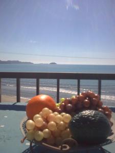 a bowl of fruit on a table with a view of the beach at Anna Koralli Studios in Laganas