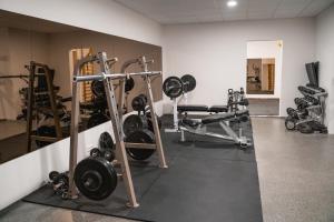 a gym with several treadmills and weights at Hótel Dyrhólaey in Vík