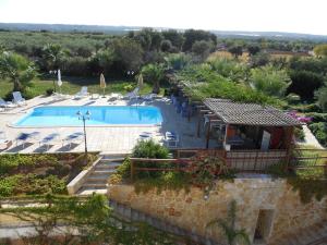 a view of a swimming pool with a resort at B&B Tenuta Martinelli in Monopoli