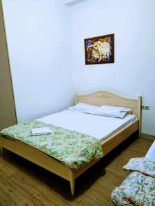 a bed sitting in a room with at Гостевой дом на Цюрупы 32,Г2 in Sochi