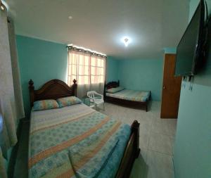 a bedroom with two beds and a large window at Casa Hostel San Andres in San Andrés +39 photos