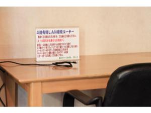 a sign sitting on top of a wooden table at Fuji Green Hotel - Vacation STAY 18928v in Fuji