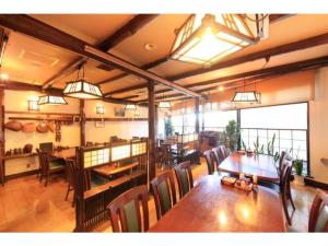 a dining room with tables and chairs and lights at Fuji Green Hotel - Vacation STAY 18934v in Fuji