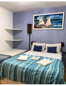 a bedroom with a bed with two towels on it at Pousada Sonho Meu in Pipa