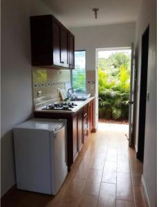 a kitchen with a sink and a stove top oven at Agua Del Caribe in Sosúa