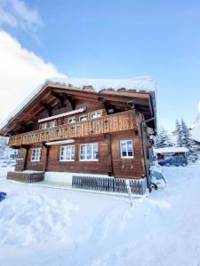 a log cabin in the snow with snow at Comfortable chalet close to ski slopes in Grindelwald