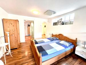 a bedroom with a bed with blue and white sheets at Pilatus Apartments in Alpnach