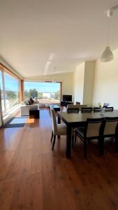 a living room with a table and chairs and a couch at Herdade do Gizo - Casa Reis in Cuba