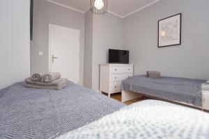 Posteľ alebo postele v izbe v ubytovaní CR Apartament Centrum Zamenhofa 1