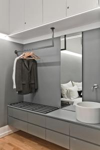 a bathroom with a sink and a mirror at BAG- Boutique Apartment Grey - Hilton Area in Athens