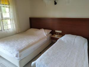 Postel nebo postele na pokoji v ubytování Olympos Yavuz Hotel