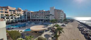 an aerial view of a resort with a pool and a beach at Peñasco del Sol Hotel in Puerto Peñasco