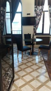a room with a table and chairs and a mirror at In the heart of the city in Kharkiv