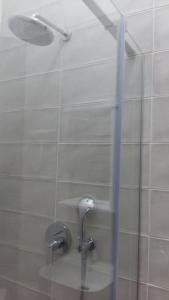 a shower with two faucets in a bathroom at In the heart of the city in Kharkiv