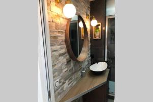 a bathroom with a sink and a mirror at Appartement vue mer et port, refait a neuf pour vous ! Climatisé in La Grande Motte
