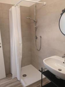 a bathroom with a shower and a sink at Battistelli Apartments in Bologna