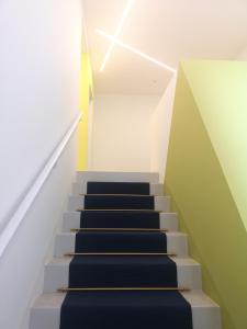 a stairway with blue and green stairs in a building at Battistelli Apartments in Bologna