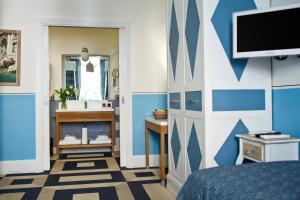 ローマにあるピアザ ディ スパナ プレステージの青と白の壁のベッドルーム1室