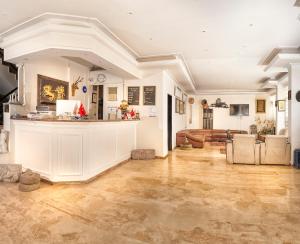 a large living room with a bar and a couch at Temple Hotel in Didim