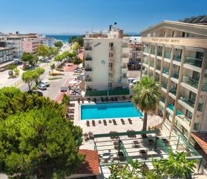 an aerial view of a city with a pool and buildings at Temple Hotel in Didim