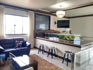 a living room with a fish tank in a kitchen at Crystal Palace Hotel in Rolim de Moura