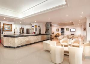 a lobby with a waiting room with white chairs at Temple Beach Hotel in Didim