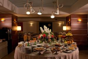 a table with plates of food and flowers on it at Virgilio Grand Hotel in Sperlonga