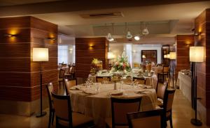 a dining room with a long table and chairs at Virgilio Grand Hotel in Sperlonga