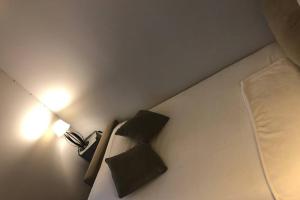 a bed with two pillows and a lamp in a room at Studio de la porte de Samois in Moret-sur-Loing