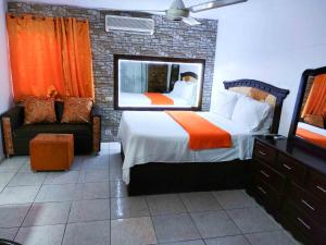 a bedroom with a large bed and a mirror at Residence Tropical Garden in Boca Chica +107 photos